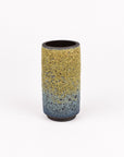 A cylindrical ceramic vase with a textured, speckled glaze featuring a yellow-to-blue gradient and dark brown base, set against a plain white background.
