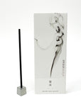Incense stick with packaging featuring smoke design on a white background