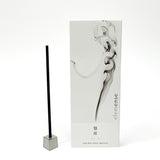 Incense stick with packaging featuring smoke design on a white background