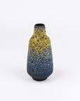 A small ceramic bottle vase with a yellow-to-blue speckled glaze, standing on a white background.