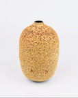 A small, rounded ceramic vase with a textured, speckled golden-brown glaze and a short, narrow neck, photographed against a seamless white background.