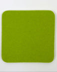 Solid green square coaster on a white background