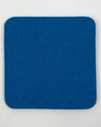 Blue square coaster on a light gray background
