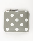Gray wallet with white polka dots on a white background
