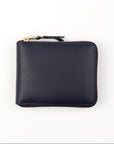 A navy blue leather wallet with a zipper closure and gold-toned metal hardware.