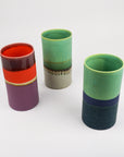 Three colorful ceramic vases on a white background