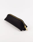 Black pouch with a gold zipper on a white background