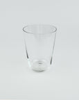 Clear glass tumbler on a light gray background