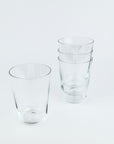 Set of clear glass tumblers on a light gray background