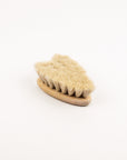 Heart shaped baby hair brush with natural bristles on a white background