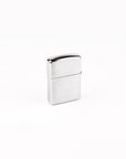 A classic rectangular metal lighter with a brushed and polished chrome finish, standing upright on a seamless white background.