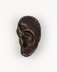 Bronze ear sculpture on a white background