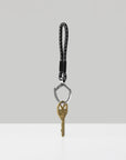 Keychain with a key on a light gray background