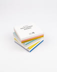 Stack of colorful memo pads with 'MOTTAINAI MEMO' text on a white background