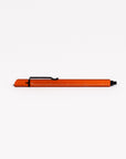 Orange pen with black clip on a white background