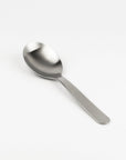 Stainless steel spoon on a white background