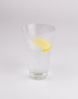 Clear glass with a lemon slice on a white background