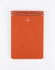 Orange spiral-bound notebook with 'POSTALCO' branding on a white background