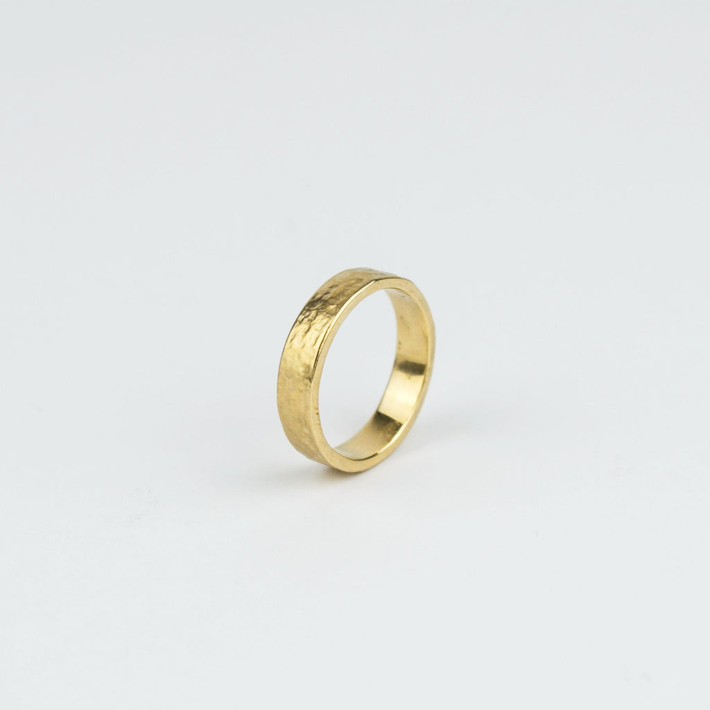 Gold ring on a light gray background