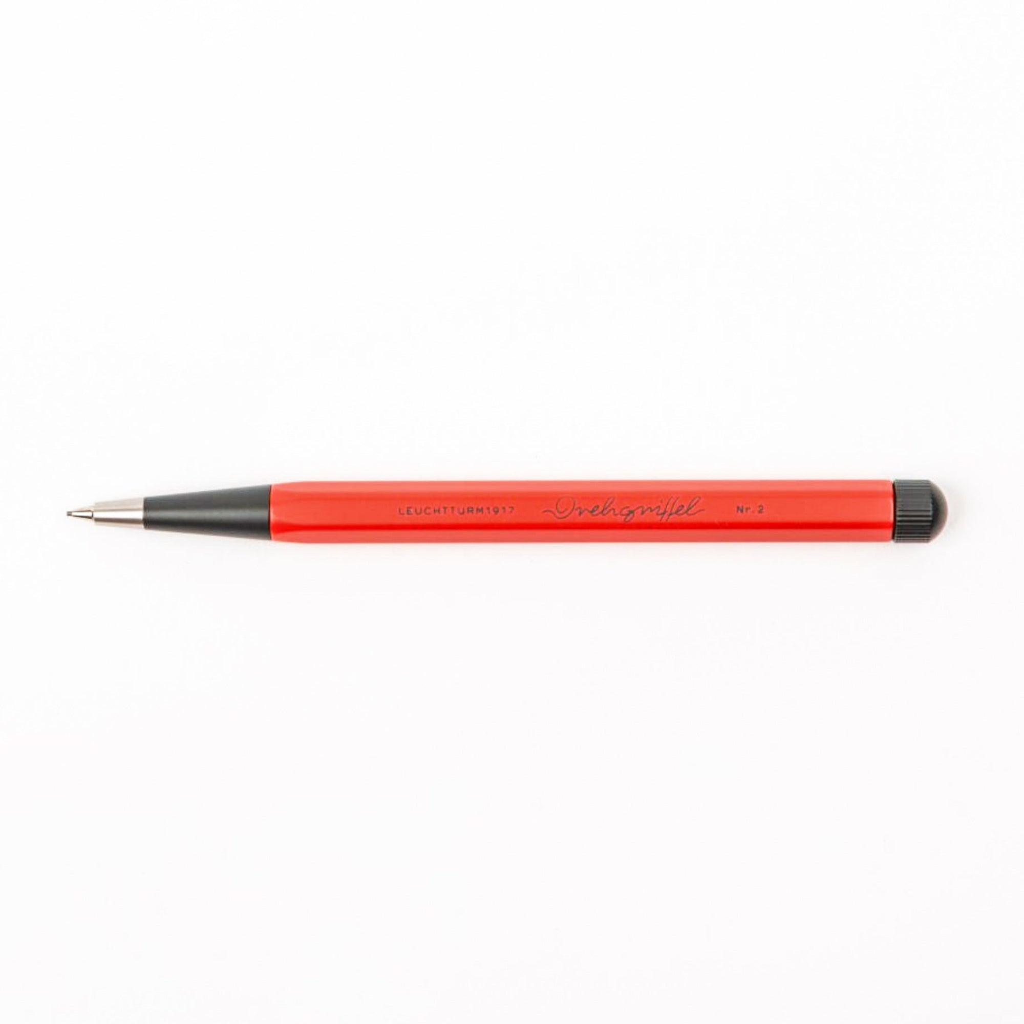 Red pen with black accents on a white background