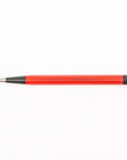 Red pen with black accents on a white background