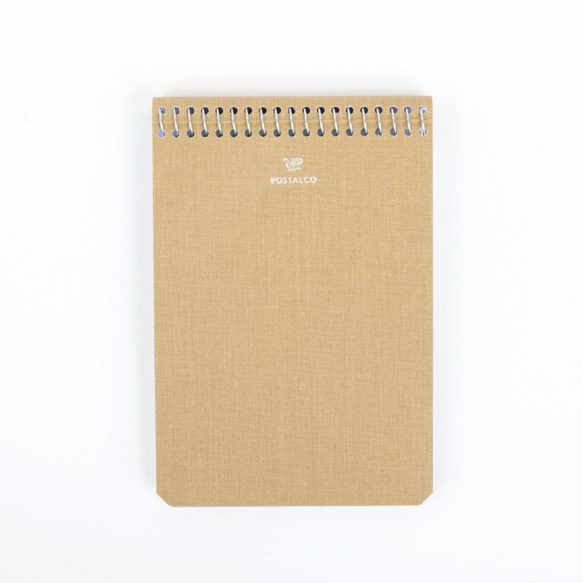 A beige, A6 medium-sized notebook with a stylized carrier pigeon logo on the cover, spiral bound.