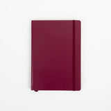 Maroon notebook on a white background
