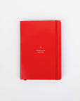 Red notebook with text on a white background