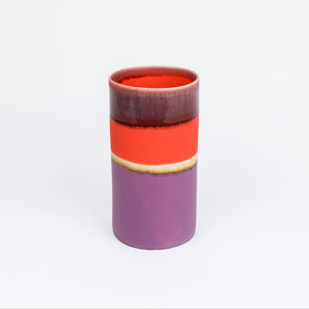 Cylindrical ceramic vase with a two-tone design on a white background