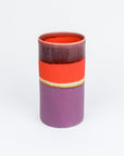 Cylindrical ceramic vase with a two-tone design on a white background