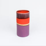 Cylindrical ceramic vase with a two-tone design on a white background