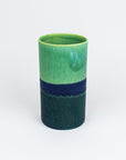 Green and blue ceramic vase on a white background