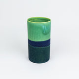 Green and blue ceramic vase on a white background