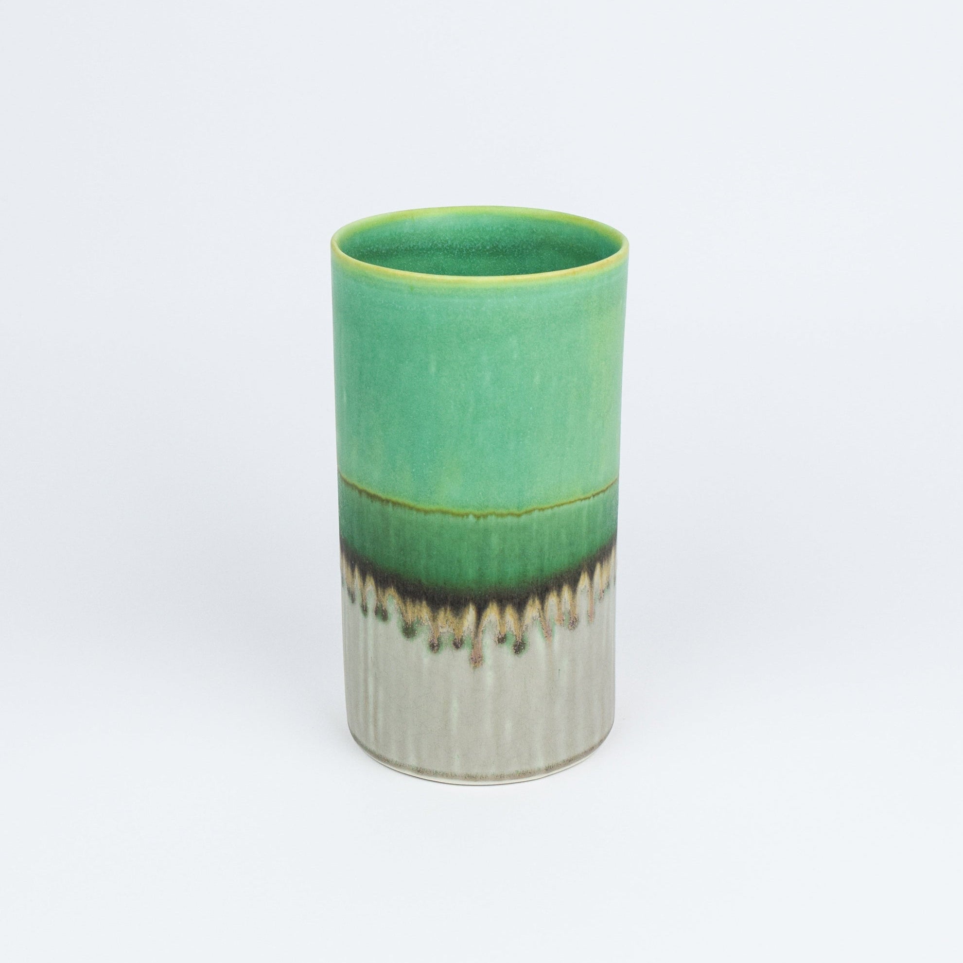 Green ceramic vase with a textured base on a white background