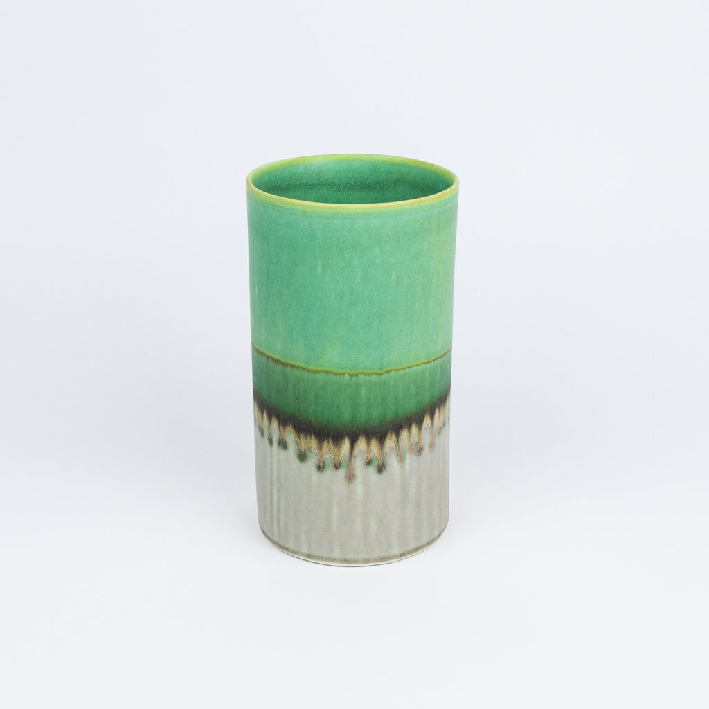 Green ceramic vase with a textured base on a white background