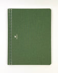Green notebook with spiral binding on a white background