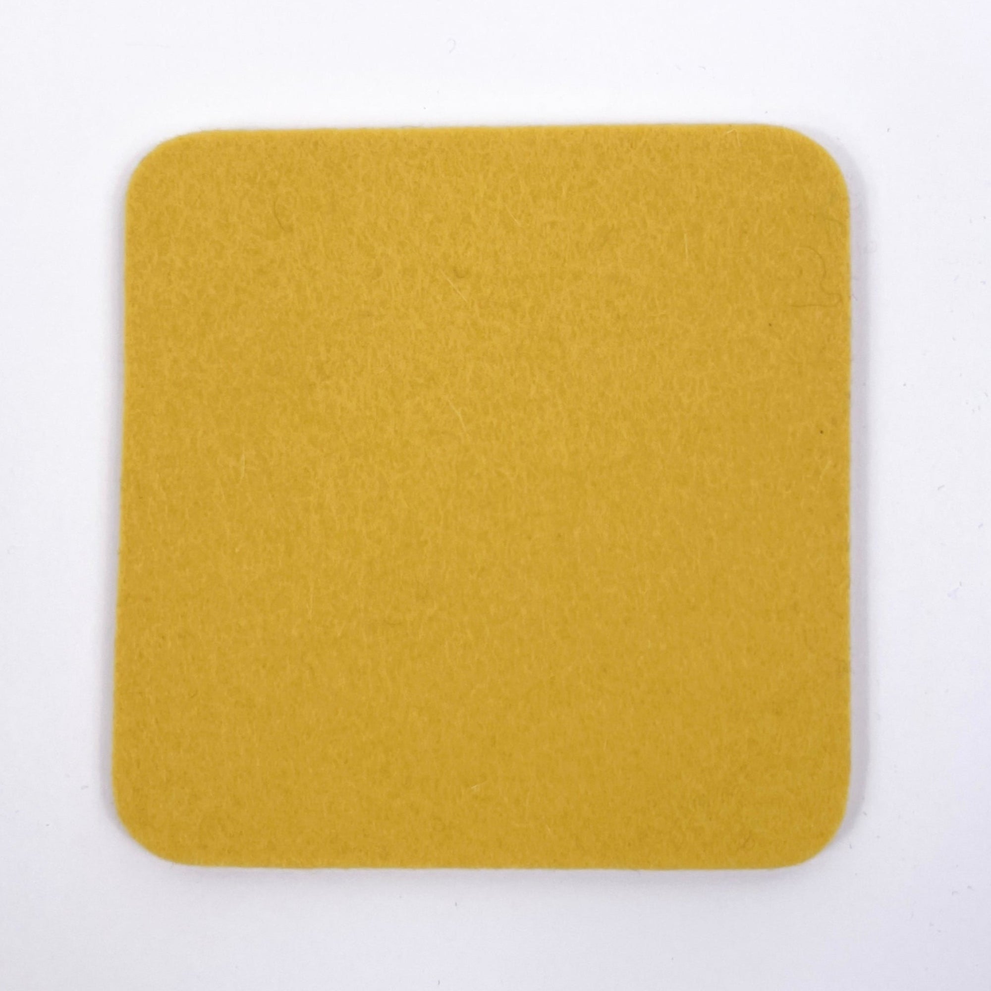 Yellow square coaster on a white background