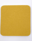 Yellow square coaster on a white background