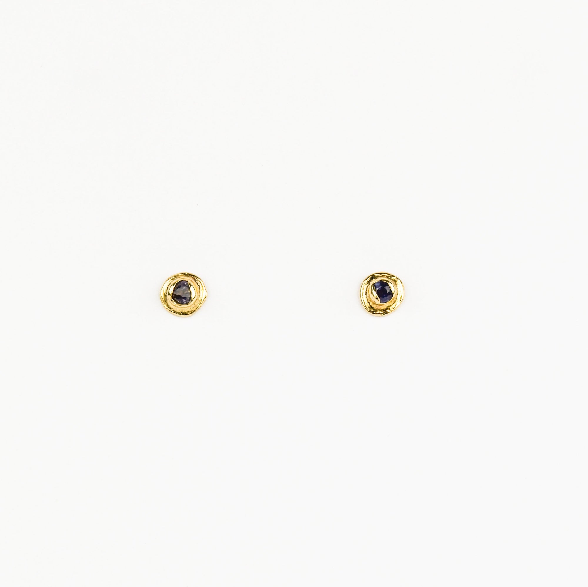 Pair of gold earrings with gemstones on a white background