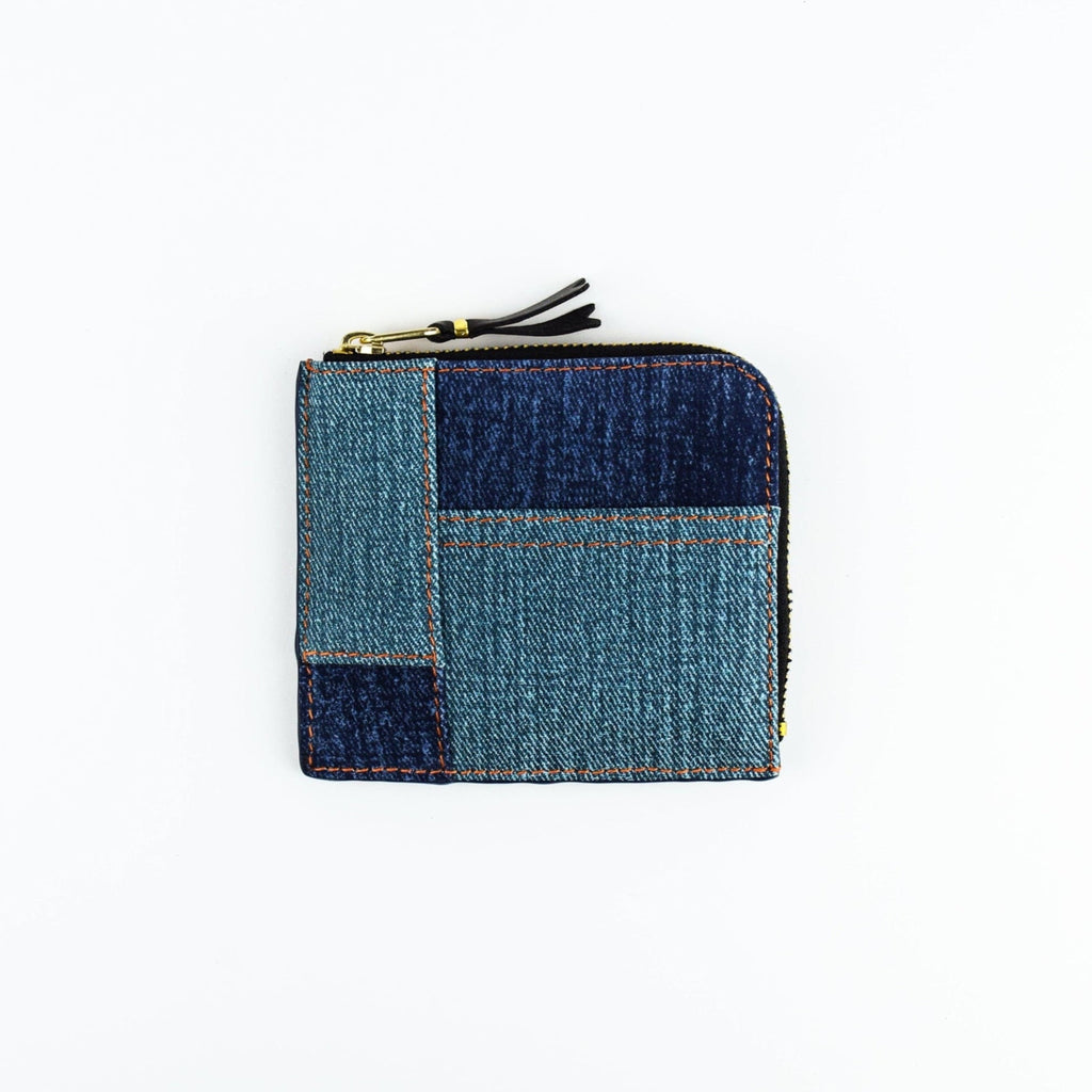 Denim patchwork wallet with a zipper on a white background