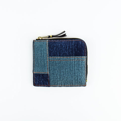 Denim patchwork wallet with a zipper on a white background
