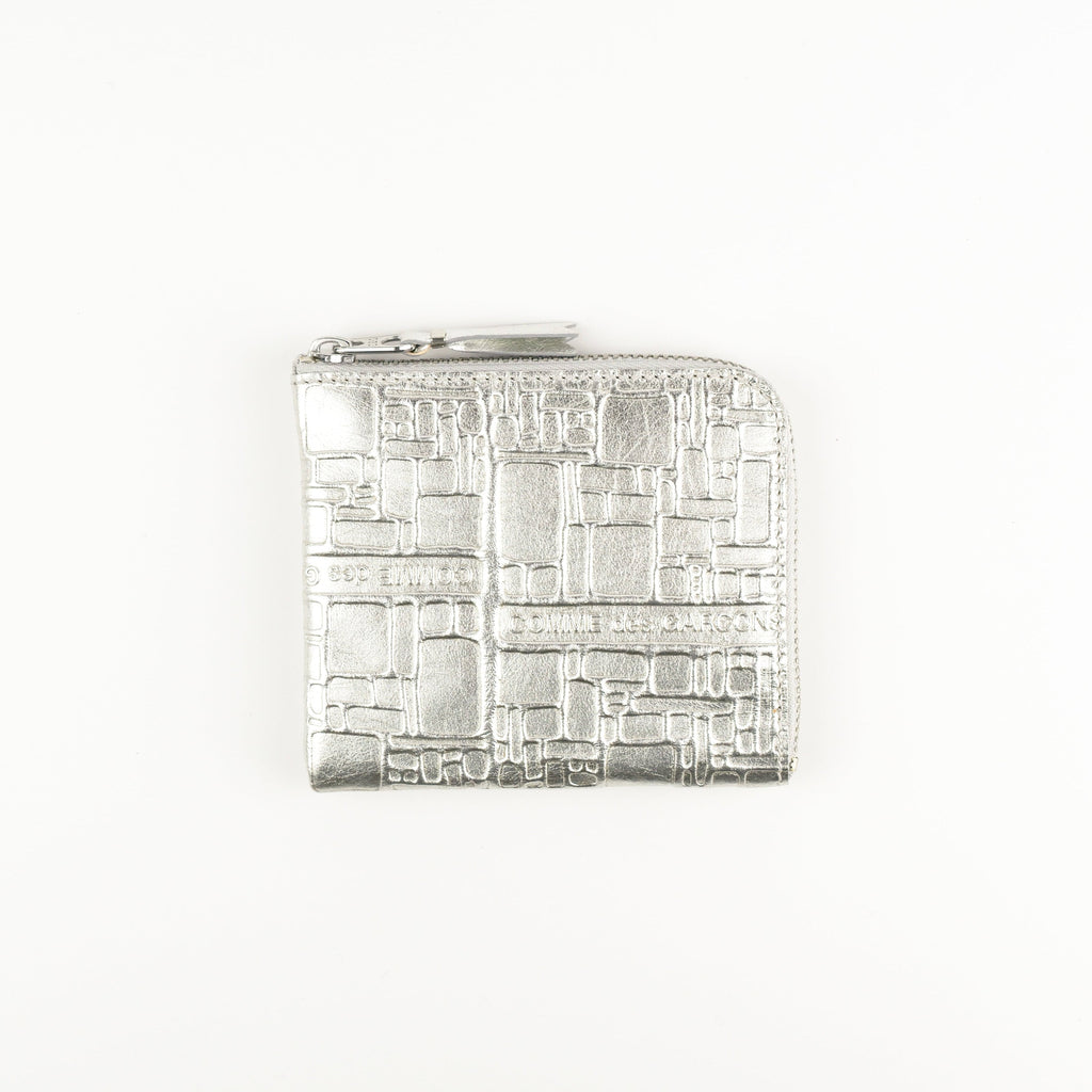 Silver rectangular wallet with intricate design on a white background