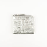Silver rectangular wallet with intricate design on a white background