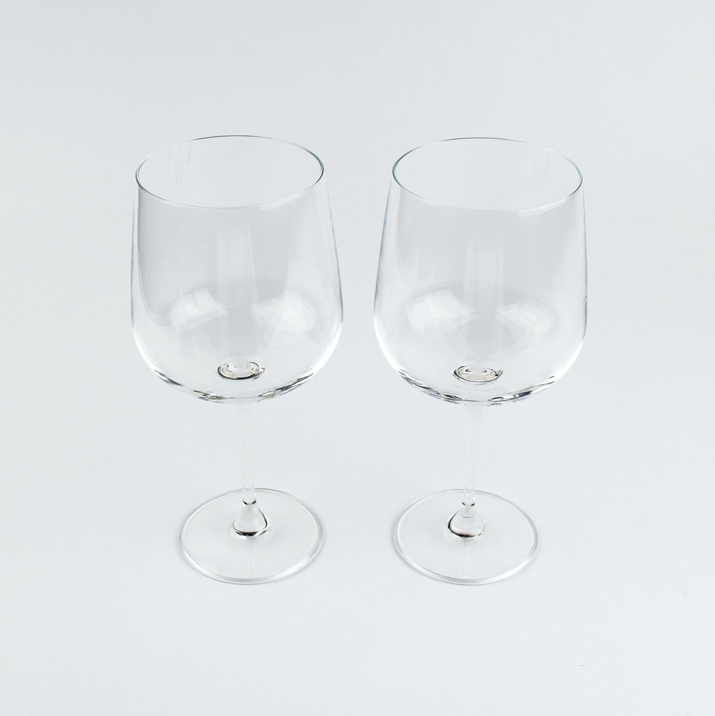 Two clear wine glasses on a white background