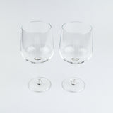 Two clear wine glasses on a white background