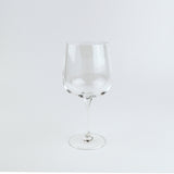 Clear wine glass on a light gray background