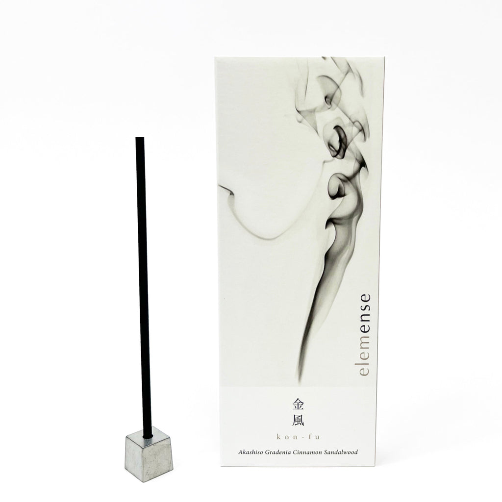 Incense stick with packaging featuring smoke design on a white background