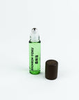 Green rollerball bottle with black cap on a white background