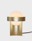 Modern wall-mounted lamp with gold finish and white bulb on a light gray background