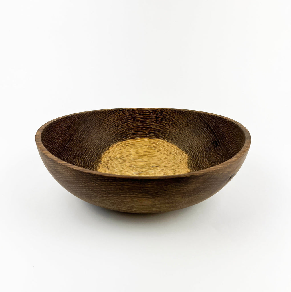 Wooden bowl with a natural finish on a white background